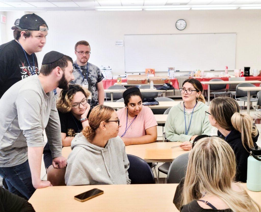 Group of diverse students sitting in a group discussion in a classroom